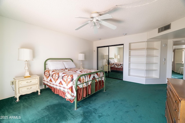 carpeted bedroom featuring a ceiling fan, a closet, visible vents, and a textured ceiling