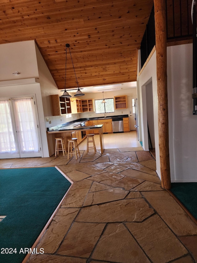 kitchen with pendant lighting, stainless steel dishwasher, wooden ceiling, and a wealth of natural light