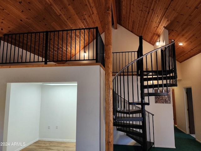 stairs with beam ceiling, wood-type flooring, wood ceiling, and high vaulted ceiling