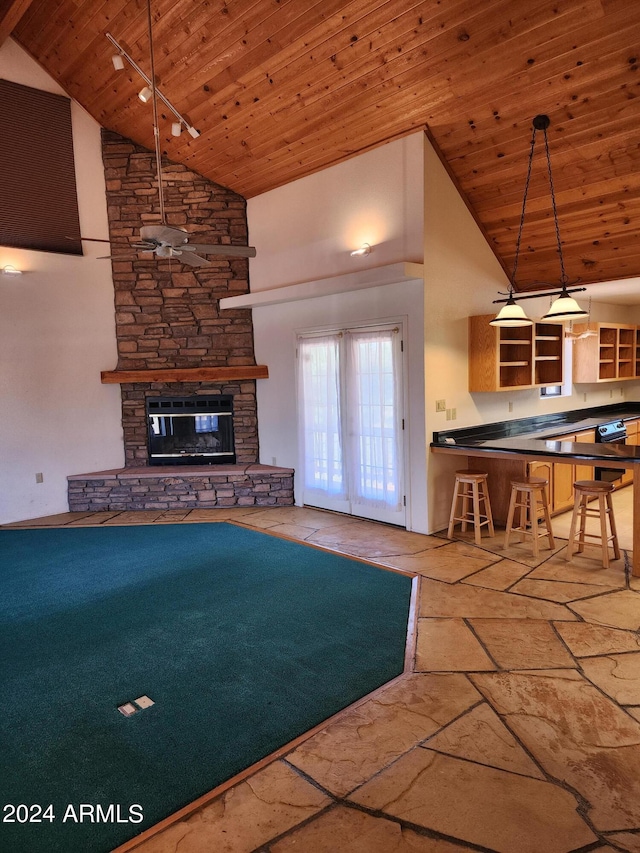 unfurnished living room featuring wooden ceiling, a fireplace, high vaulted ceiling, and french doors