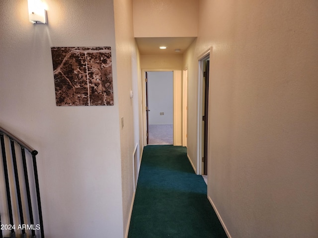 hallway featuring dark carpet