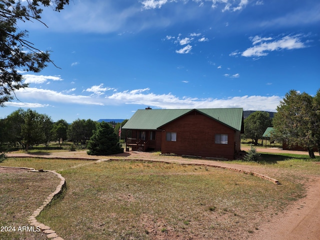 view of side of property with a lawn