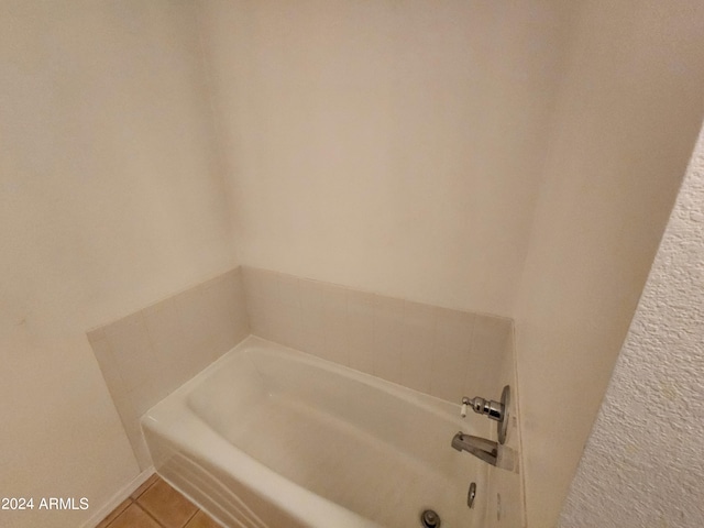 bathroom featuring tile patterned floors and a tub