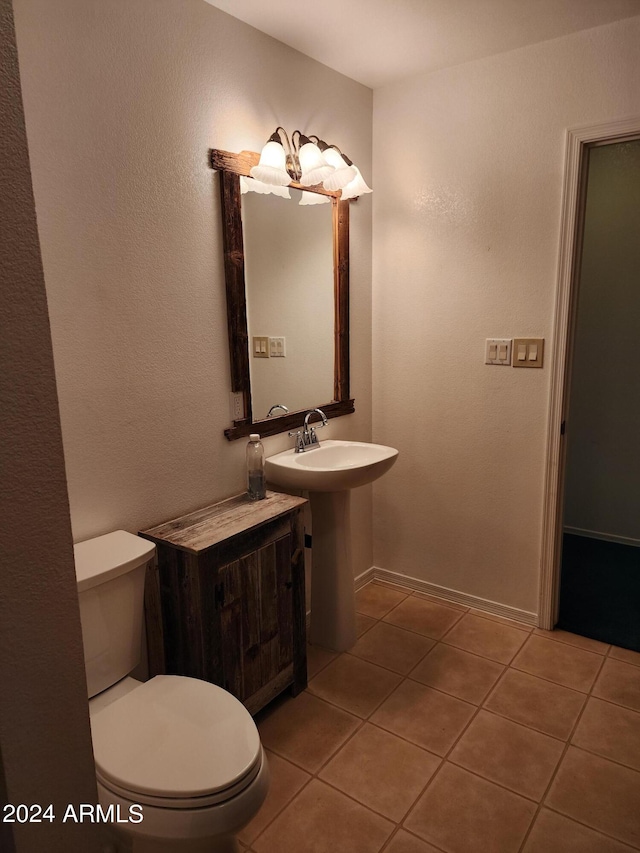 bathroom with tile patterned flooring and toilet