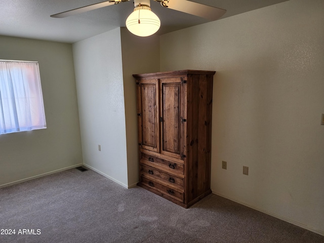 unfurnished bedroom featuring light colored carpet and ceiling fan