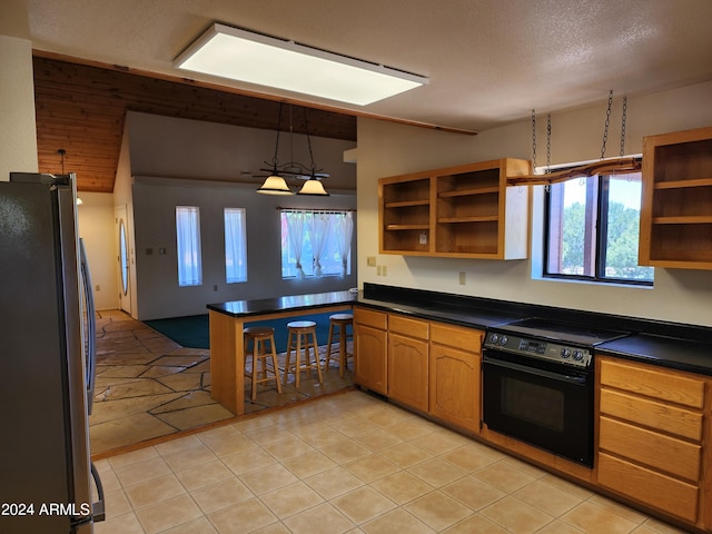 kitchen featuring stainless steel refrigerator, black range with electric cooktop, pendant lighting, a textured ceiling, and light tile patterned floors