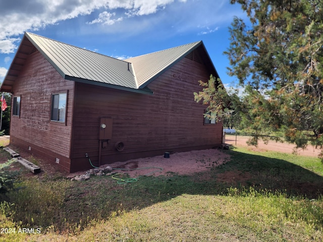 view of home's exterior with a lawn