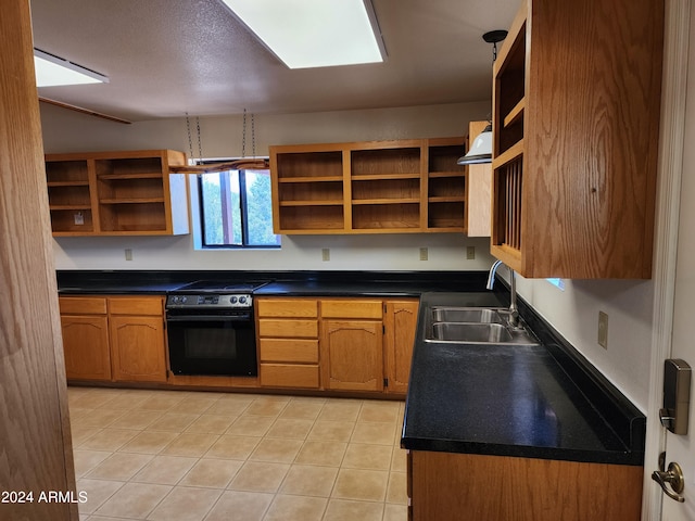 kitchen with light tile patterned floors, sink, and black appliances