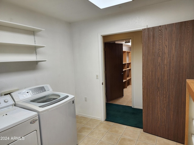 washroom featuring light tile patterned floors and washer and clothes dryer