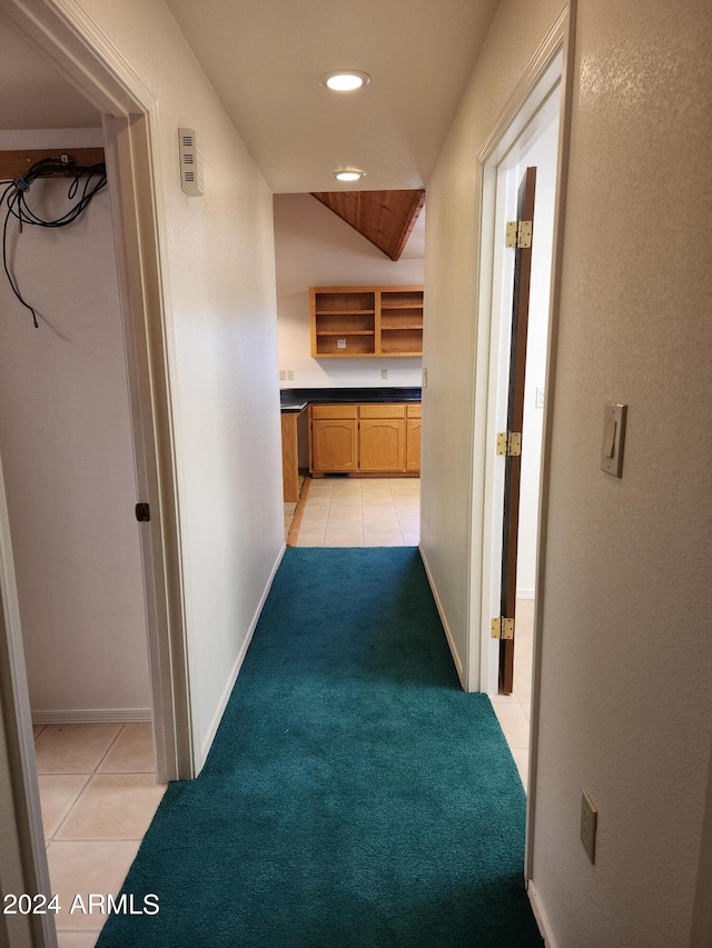 hallway featuring light colored carpet