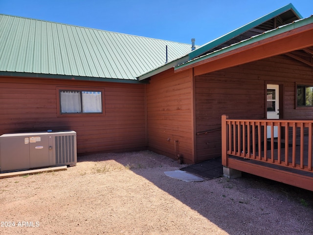 view of home's exterior with central AC unit and a deck