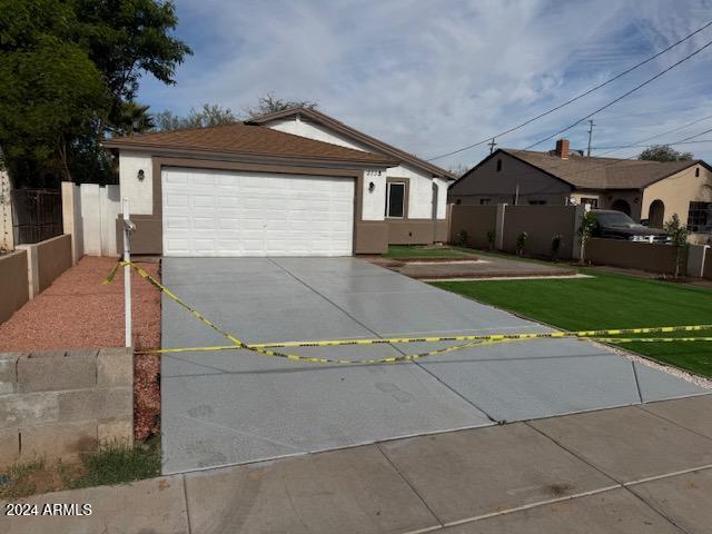 single story home with a front lawn and a garage