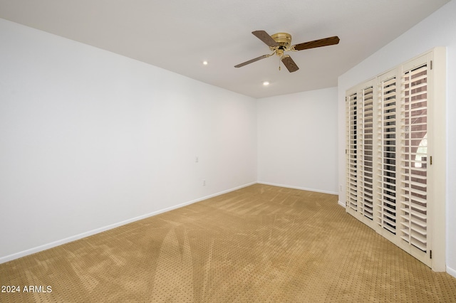 unfurnished bedroom with ceiling fan and light carpet