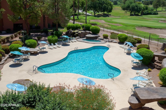 view of swimming pool with a patio area