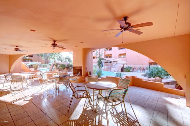 tiled dining space with ceiling fan