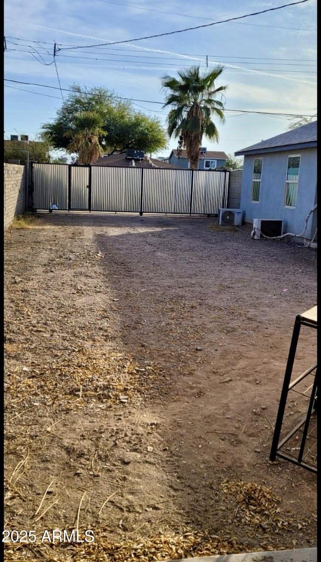 view of yard with fence and a gate