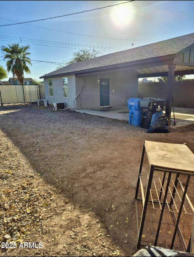 rear view of property featuring a patio area and fence