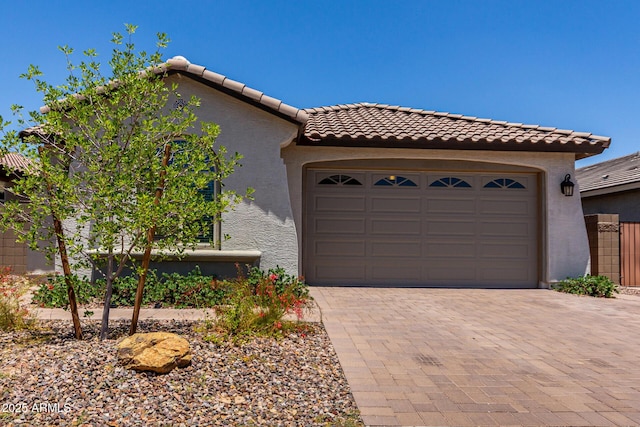 2818 W Fain Dr, San Tan Valley, AZ 85144 - mediterranean / spanish home with a garage, a tile roof, decorative driveway, and stucco siding