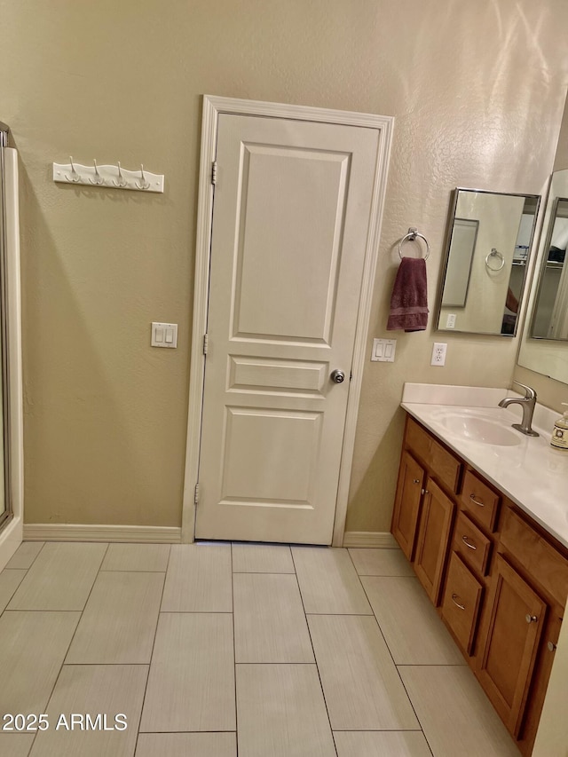 bathroom with baseboards and vanity