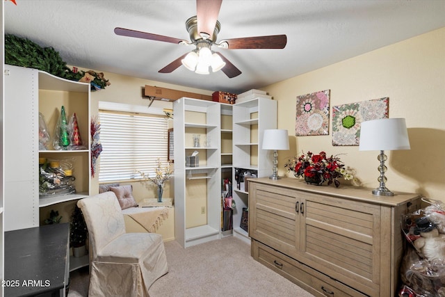 bedroom with light carpet and a ceiling fan