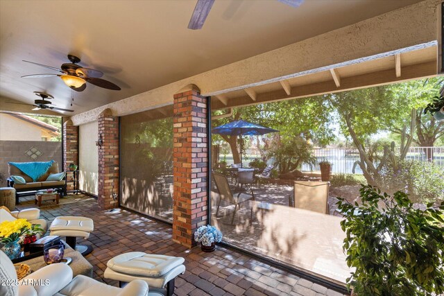 view of patio / terrace with ceiling fan, fence, outdoor dining area, and an outdoor hangout area