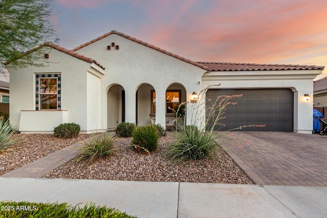 1931 E Aster Pl, Chandler, AZ 85286 - mediterranean / spanish house with an attached garage, stucco siding, decorative driveway, and a tile roof