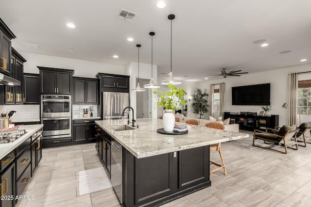 1931 E Aster Pl, Chandler, AZ 85286 - kitchen featuring stainless steel appliances, backsplash, dark cabinetry, a ceiling fan, and recessed lighting