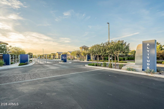 1931 E Aster Pl, Chandler, AZ 85286 - view of asphalt street featuring curbs, sidewalks, street lighting, a gated entry, and a gate