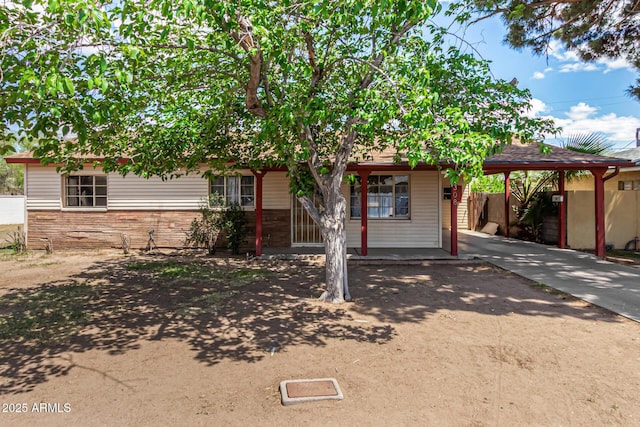 2308 W Marlette Ave, Phoenix, AZ 85015 - view of property hidden behind natural elements with fence, a carport, and driveway