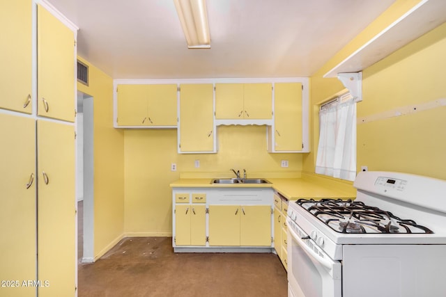 2308 W Marlette Ave, Phoenix, AZ 85015 - kitchen with visible vents, baseboards, white gas range, light countertops, and a sink