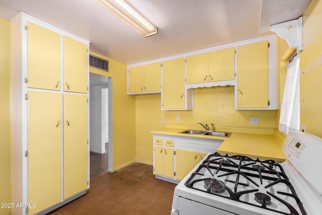 2308 W Marlette Ave, Phoenix, AZ 85015 - kitchen featuring visible vents, baseboards, light countertops, white range with gas cooktop, and a sink