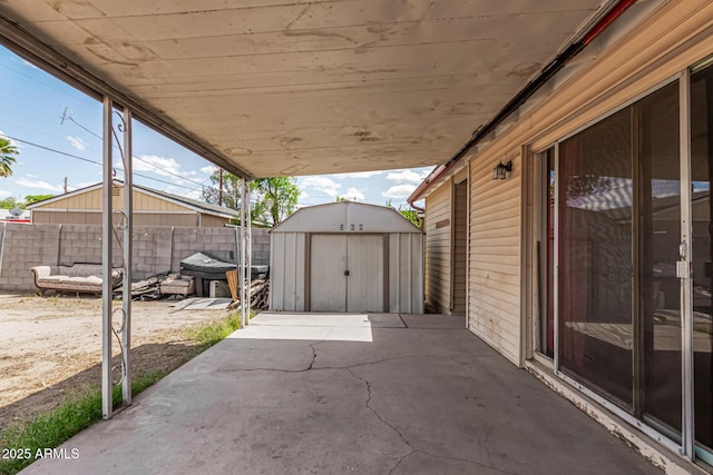 2308 W Marlette Ave, Phoenix, AZ 85015 - view of patio with fence, a storage unit, and an outbuilding