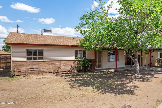2308 W Marlette Ave, Phoenix, AZ 85015 - ranch-style home with roof with shingles, fence, a chimney, and stone siding