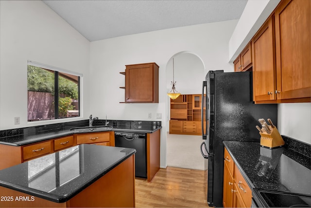 kitchen with a sink, open shelves, black appliances, light wood finished floors, and brown cabinetry