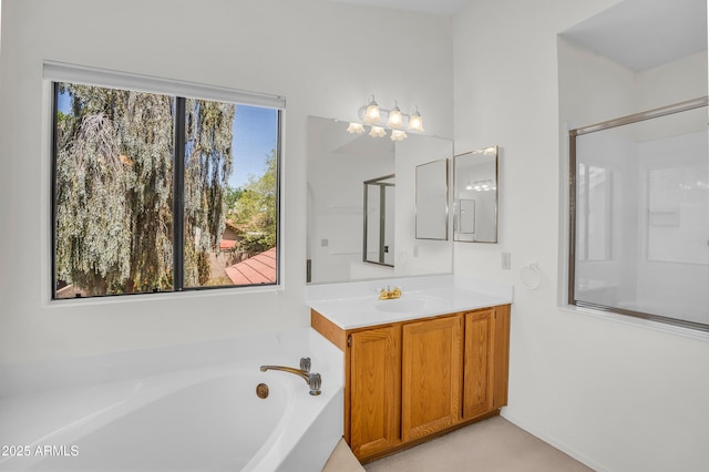 full bathroom featuring a garden tub and vanity