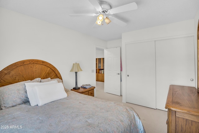 bedroom with a closet, light carpet, and ceiling fan