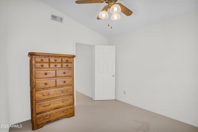 carpeted bedroom with vaulted ceiling and a ceiling fan