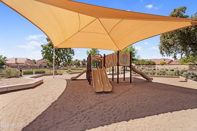 communal playground featuring fence
