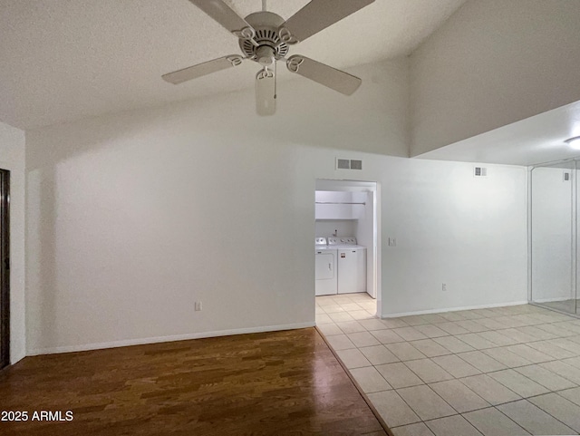 unfurnished room with ceiling fan, visible vents, baseboards, light wood finished floors, and washer and clothes dryer