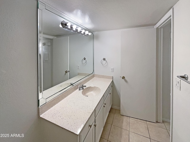 bathroom featuring tile patterned flooring, a textured ceiling, and vanity