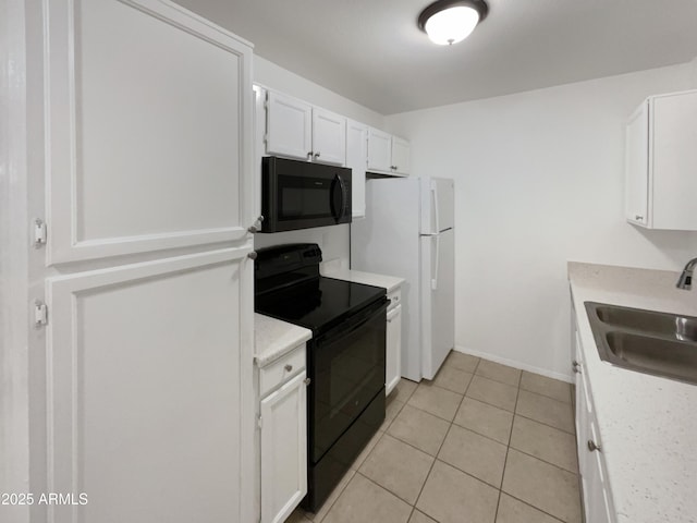 kitchen featuring a sink, black appliances, light countertops, and white cabinetry