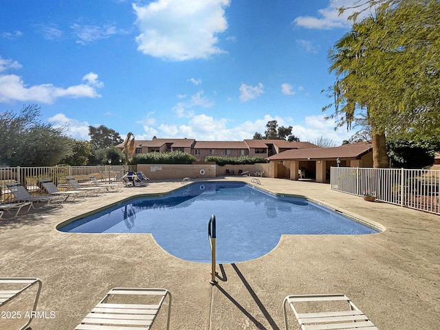 community pool featuring a patio area and fence