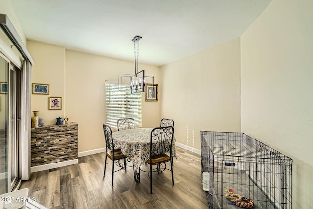 dining room with wood-type flooring and a chandelier