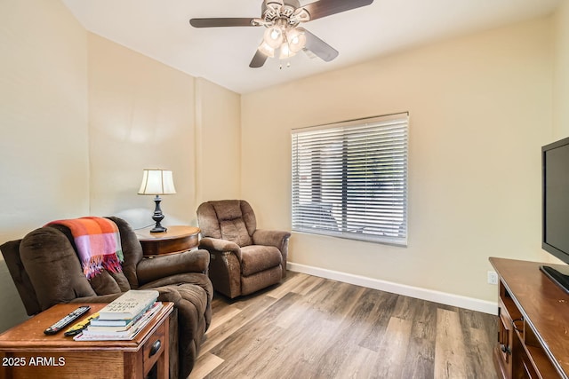 living room with ceiling fan and light hardwood / wood-style floors