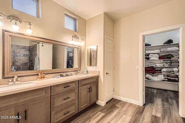 bathroom with vanity, hardwood / wood-style floors, and walk in shower