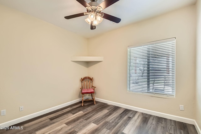 empty room featuring dark hardwood / wood-style flooring and ceiling fan