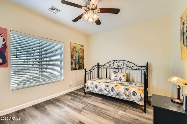 bedroom with hardwood / wood-style floors and ceiling fan