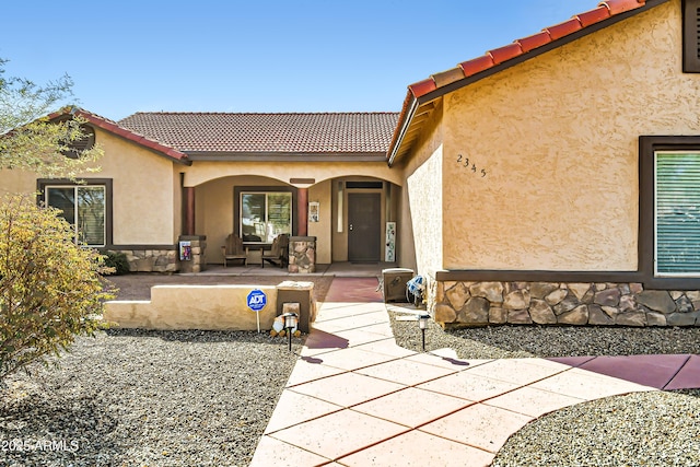 property entrance with a patio area