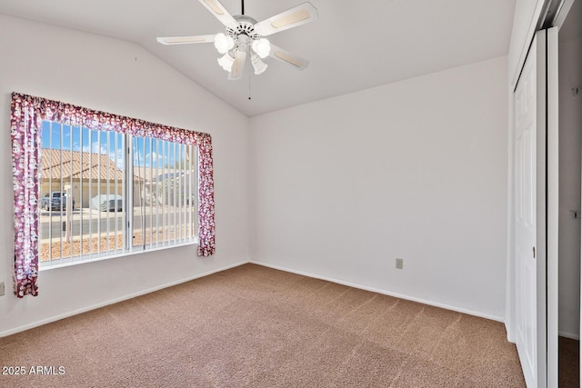 unfurnished bedroom with a closet, carpet flooring, baseboards, and lofted ceiling
