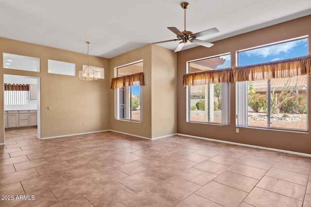 unfurnished room with baseboards, plenty of natural light, and ceiling fan with notable chandelier